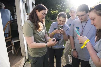 students taking pictures of caught bird at foreman's branch bird observatory